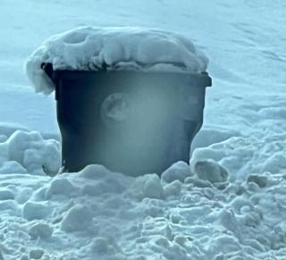 snow covered trash can