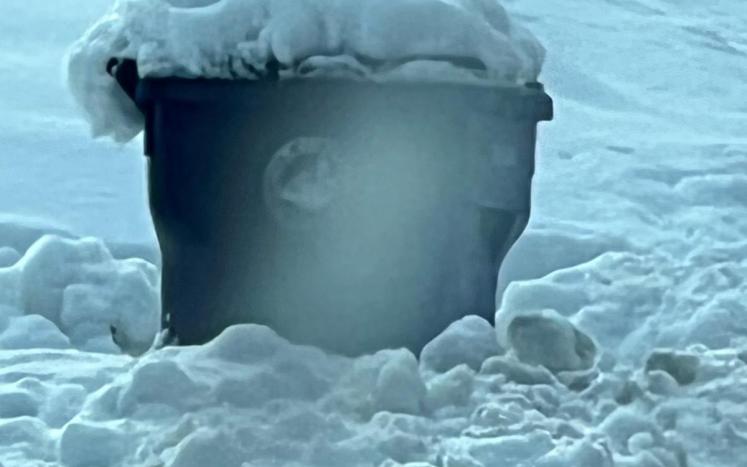 snow covered trash can
